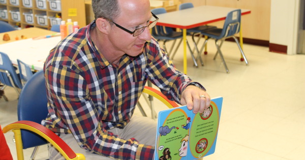 Dr. Jerald Altman reading Don't Stick Sticks Up Your Nose! Don't Stuff Stuff In Your Ears! to 3-year-old kids