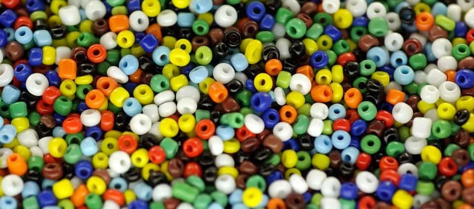 Beads in various colors used in children's craft and educational activities for teaching safety awareness from "Don't Stick Don't Stuff" book.