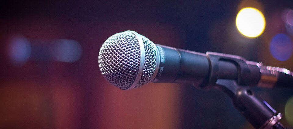 Microphone on a stand, ready for a speech or performance at a kid's safety event or book reading about staying safe, as featured in “Don’t Stick Don’t Stuff” children’s safety book.