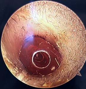 Metallic circular object resembling a sewer or drain opening with rust and grime, emphasizing the importance of water safety for children, consistent with the "Don't Stick Don't Stuff" safety education.