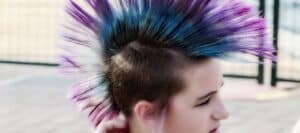 Pink and blue hairstyle of a young person with a punk style, promoting kids' safety and awareness from the "Don't Stick Don't Stuff" educational book.