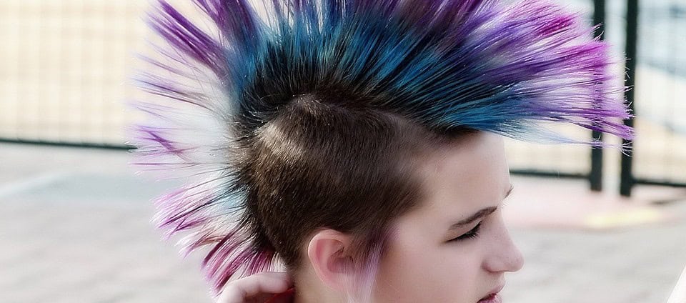 Pink and blue hairstyle of a young person with a punk style, promoting kids' safety and awareness from the "Don't Stick Don't Stuff" educational book.