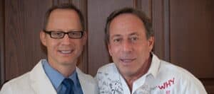 A doctor and a man in a white shirt with handwritten messages and questions, promoting children's safety and health education through "Don't Stick Don't Stuff" book.