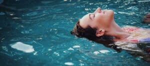 Girl floating on water demonstrating safety awareness and relaxation.